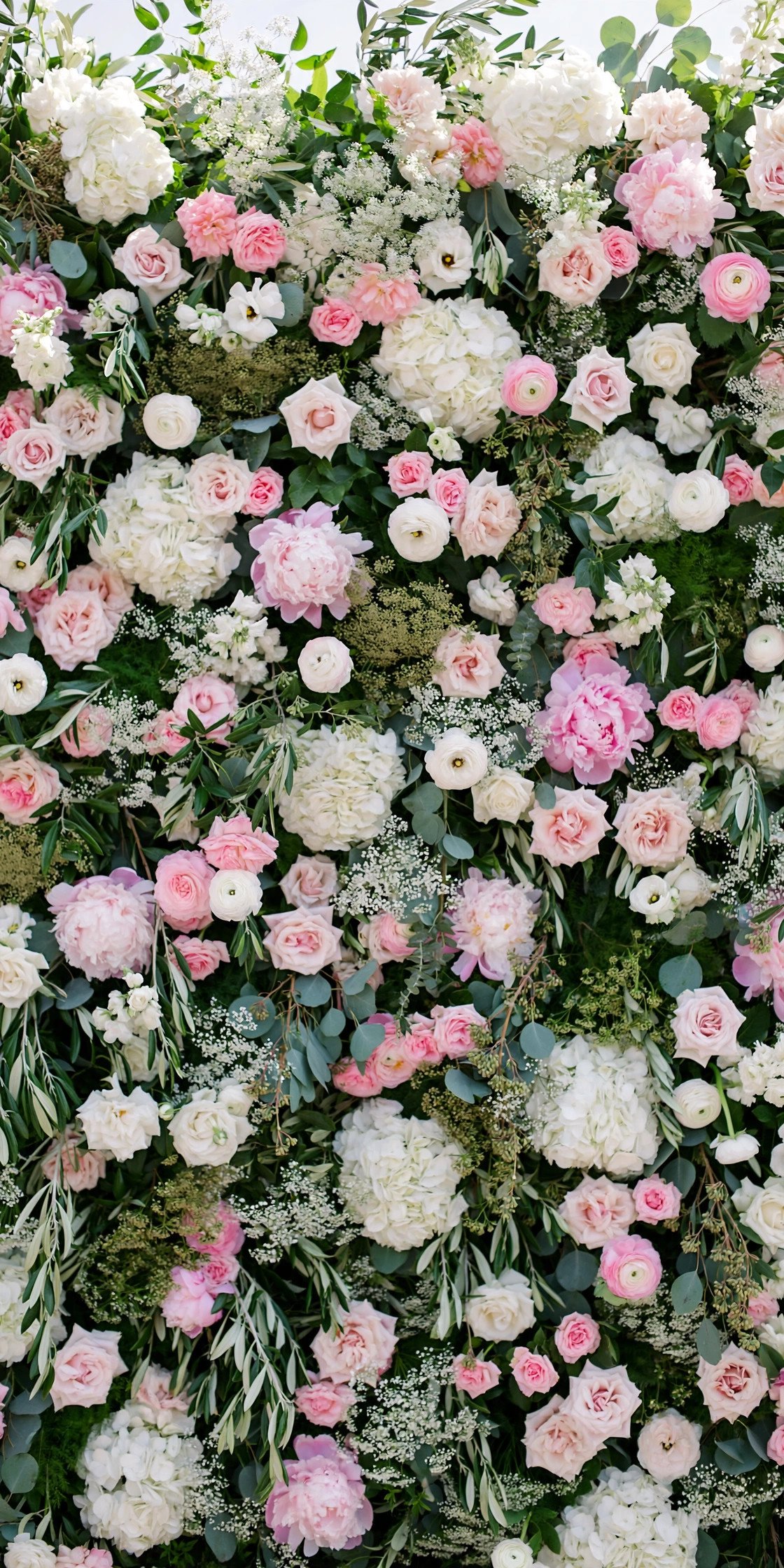 Lush flower wall backdrop for wedding photos with pink and white blooms