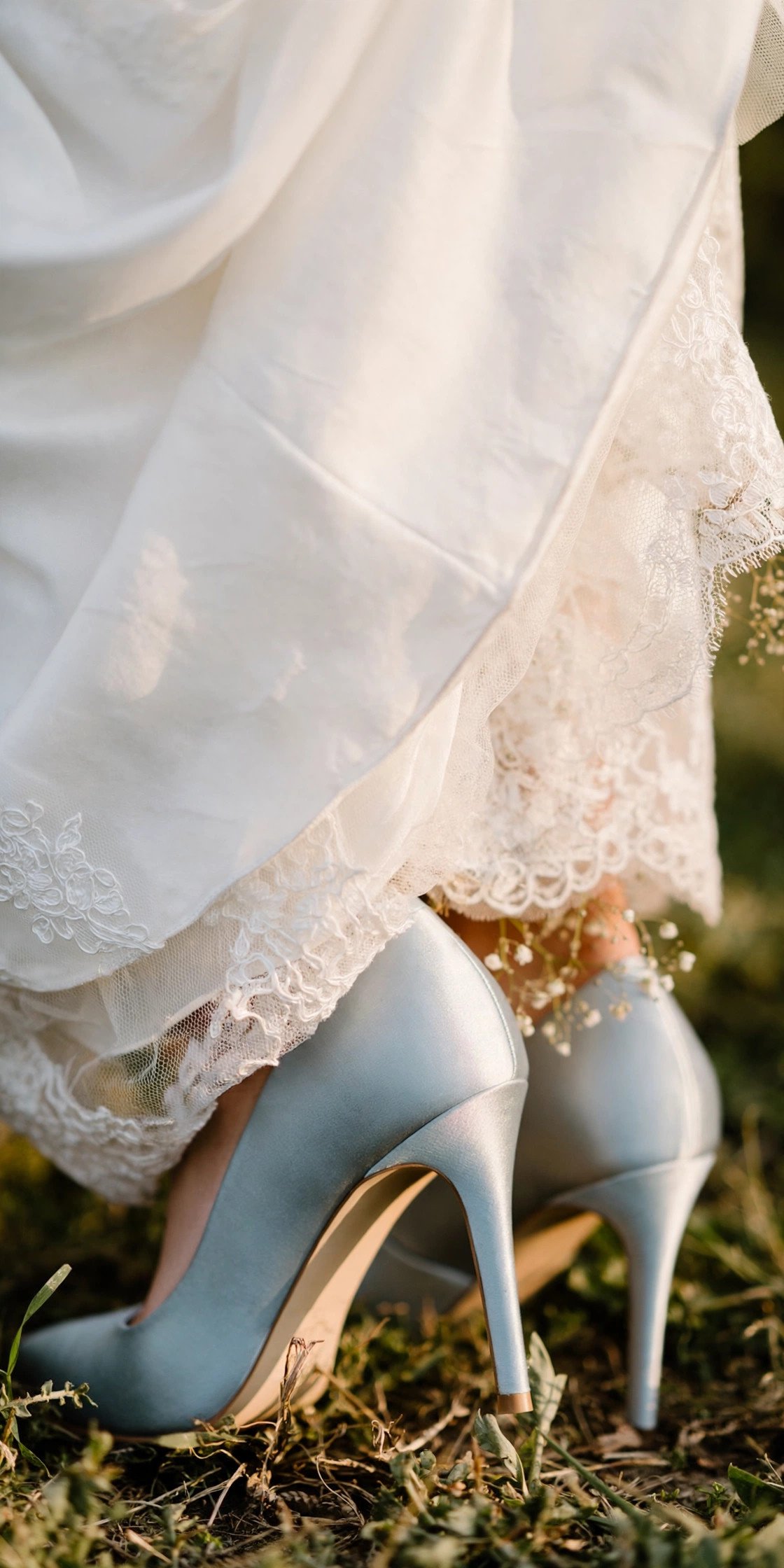 Bride wearing pale blue satin wedding heels under her gown