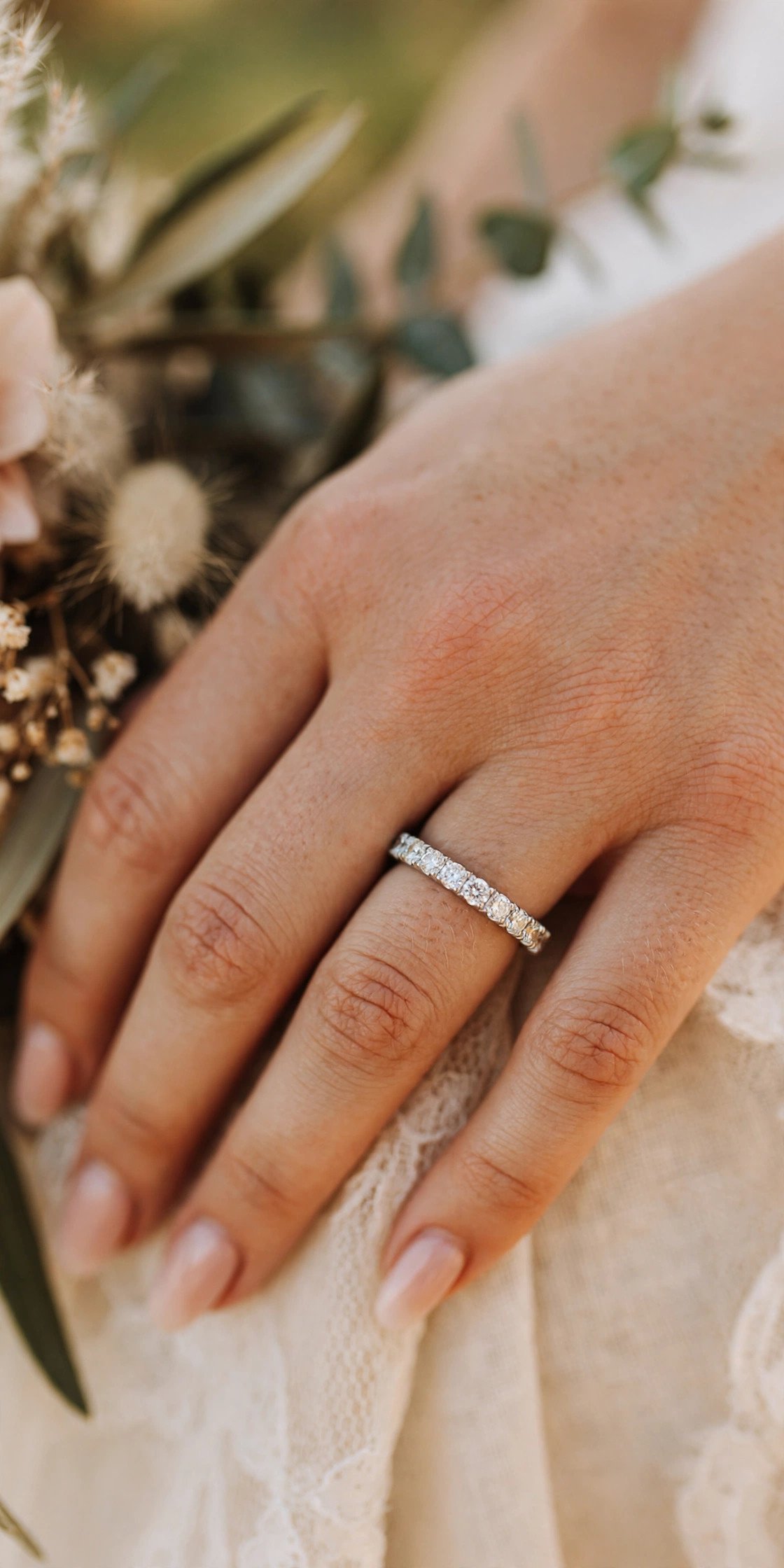 Full eternity diamond wedding band sparkling on a ring finger